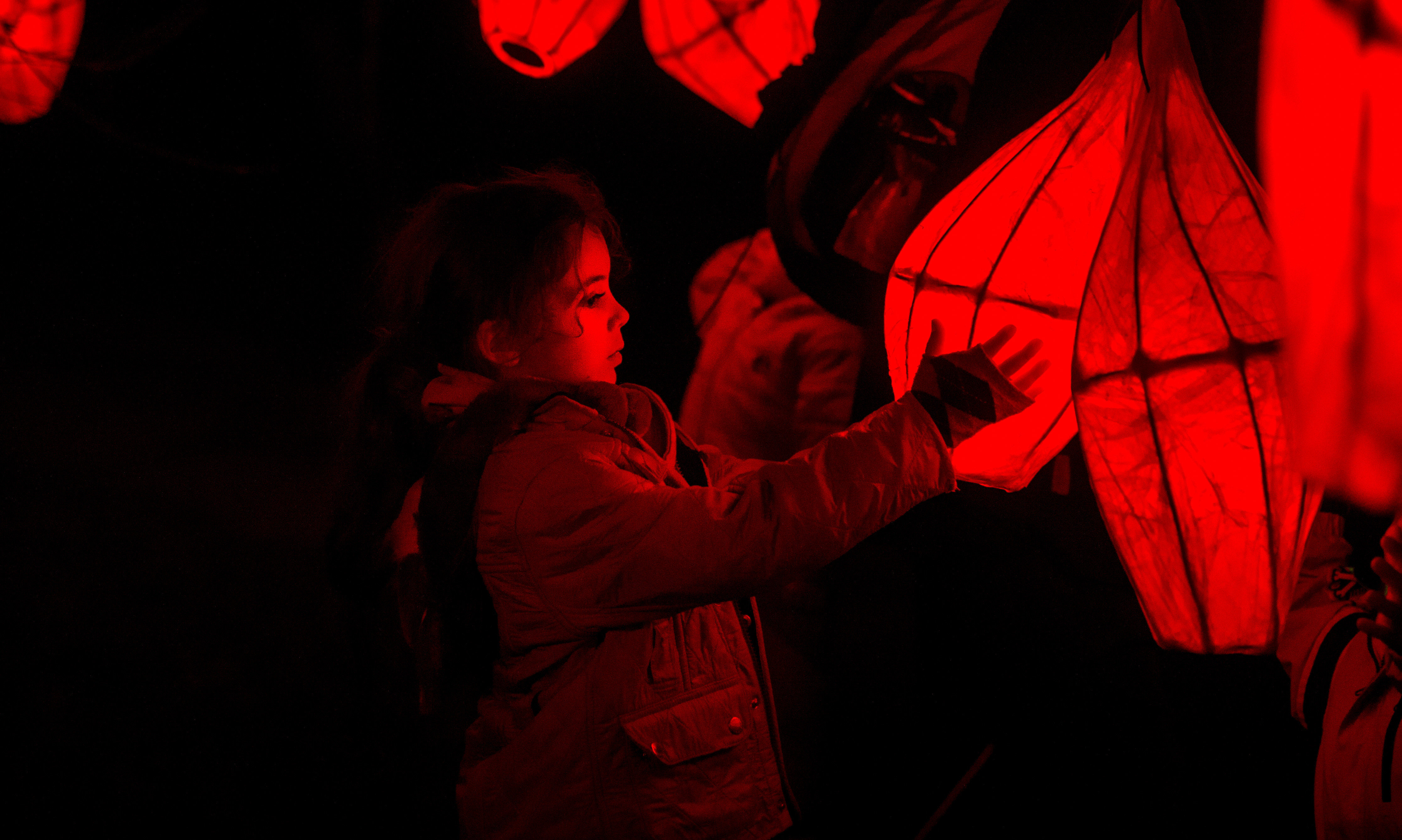Girl holding red lantern at Glow Wild