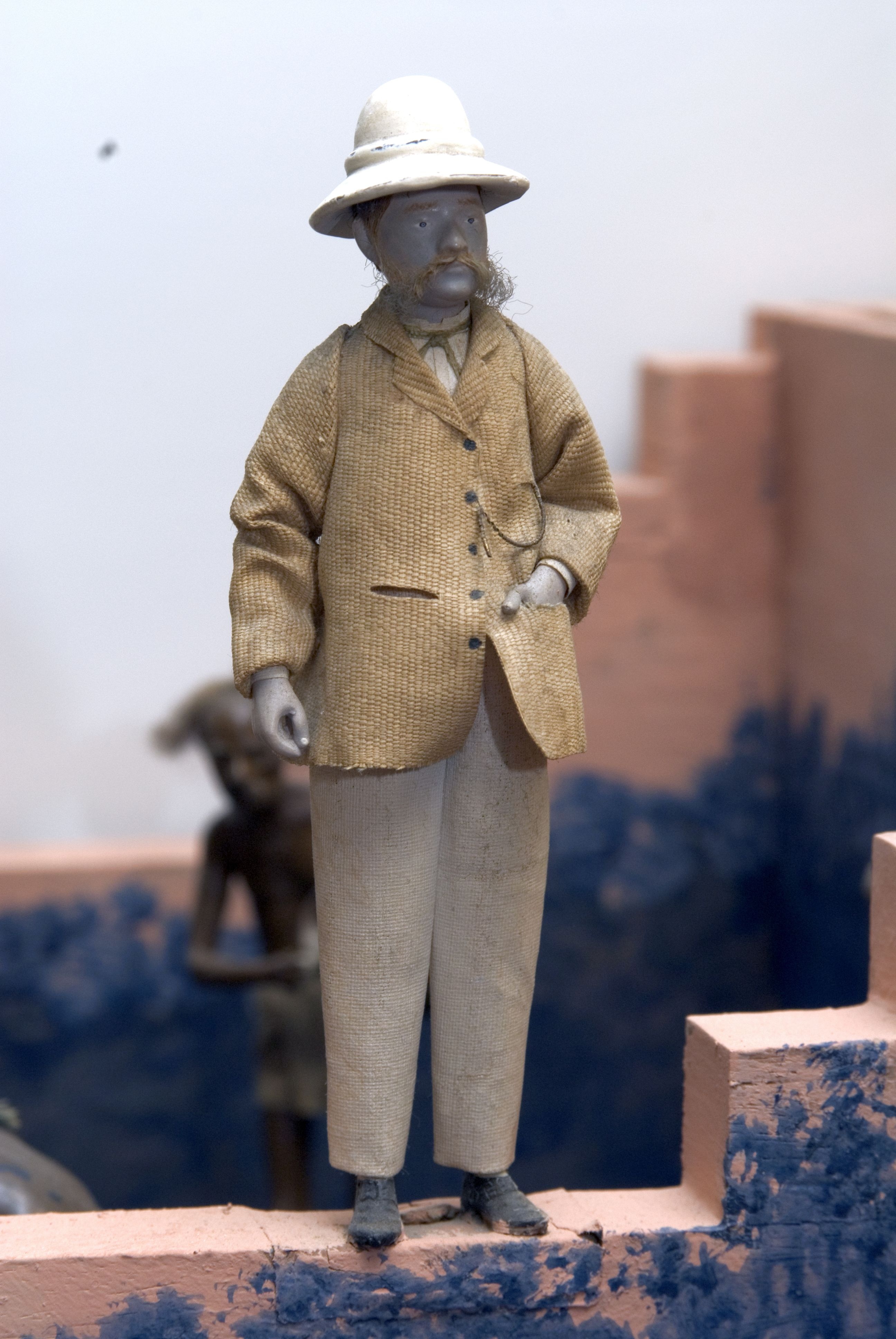 The figure of a European manager in pith helmet surveys the scene