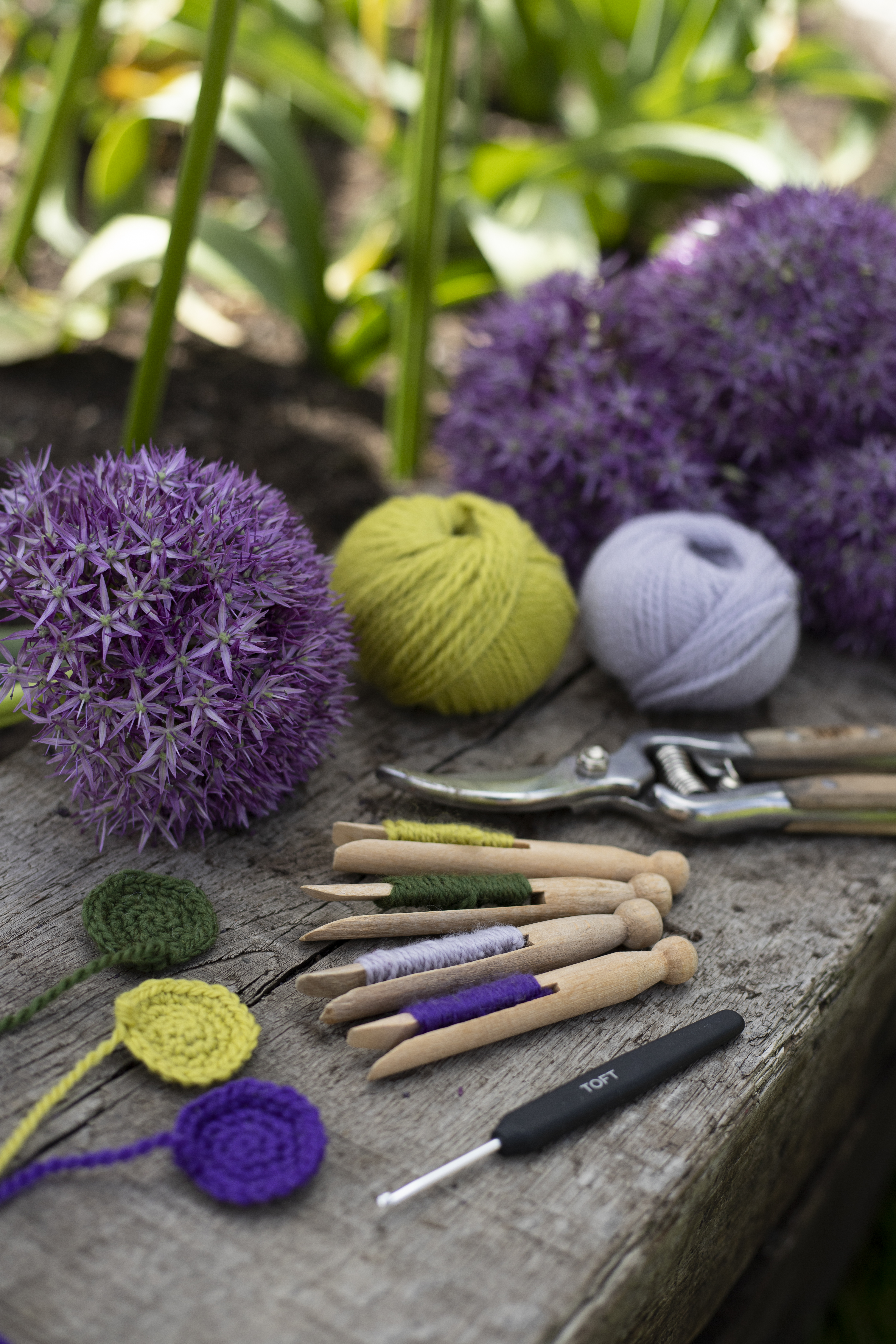 A collection of crochet equipment including coloured wool and hooks