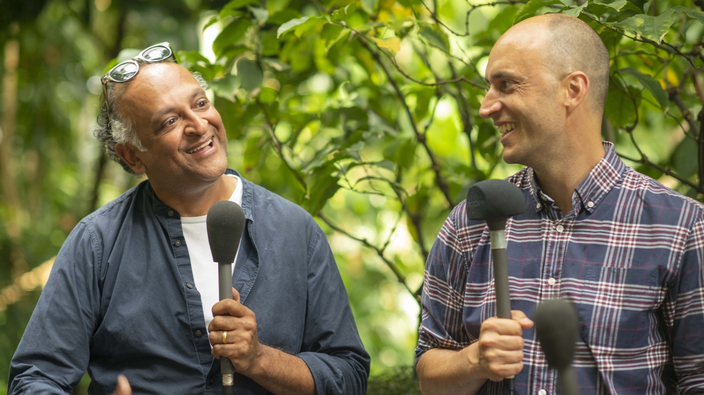 Two men sitting in the Palm House speaking into microphones