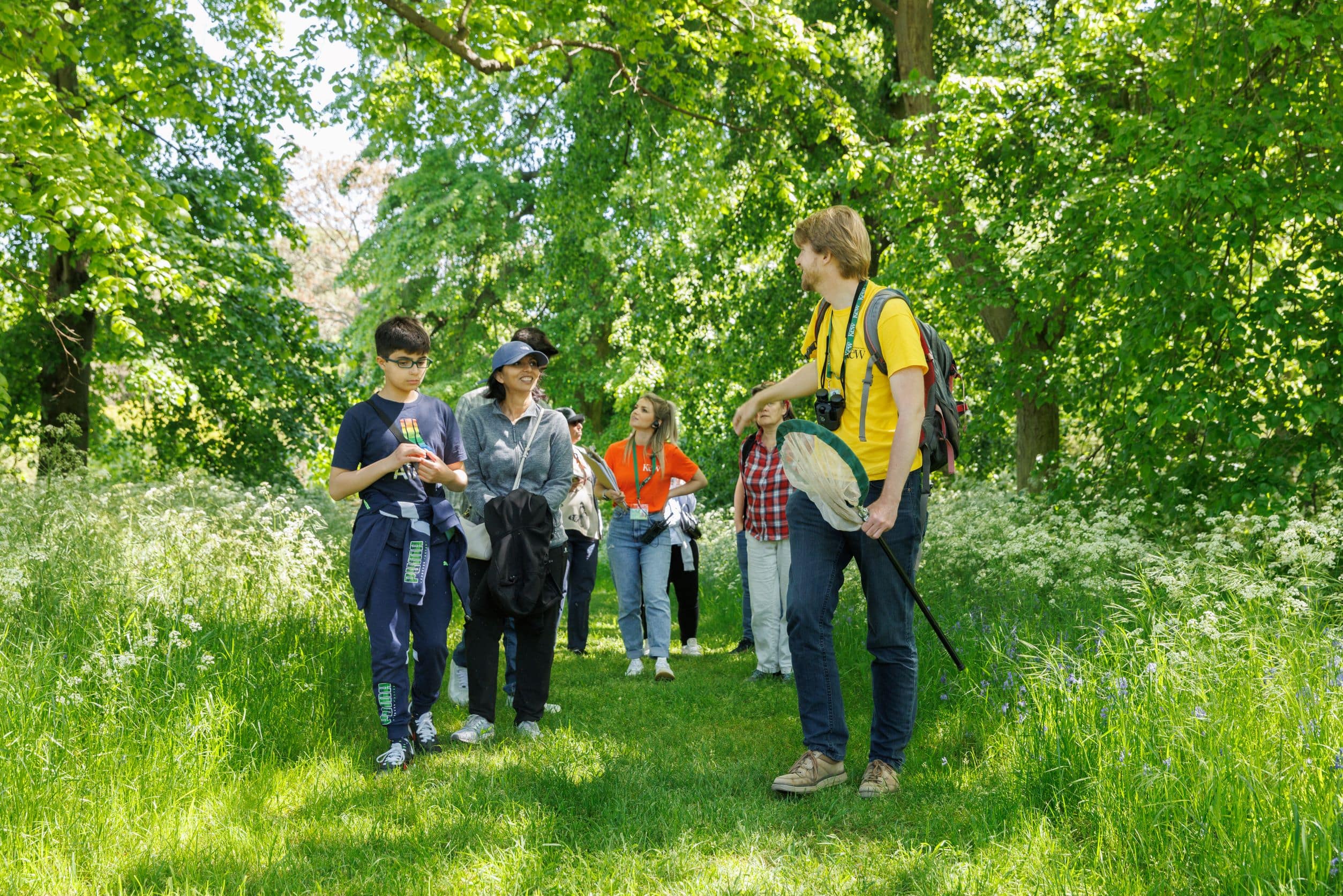 Kew scientist leading a group of people on a pollination trail