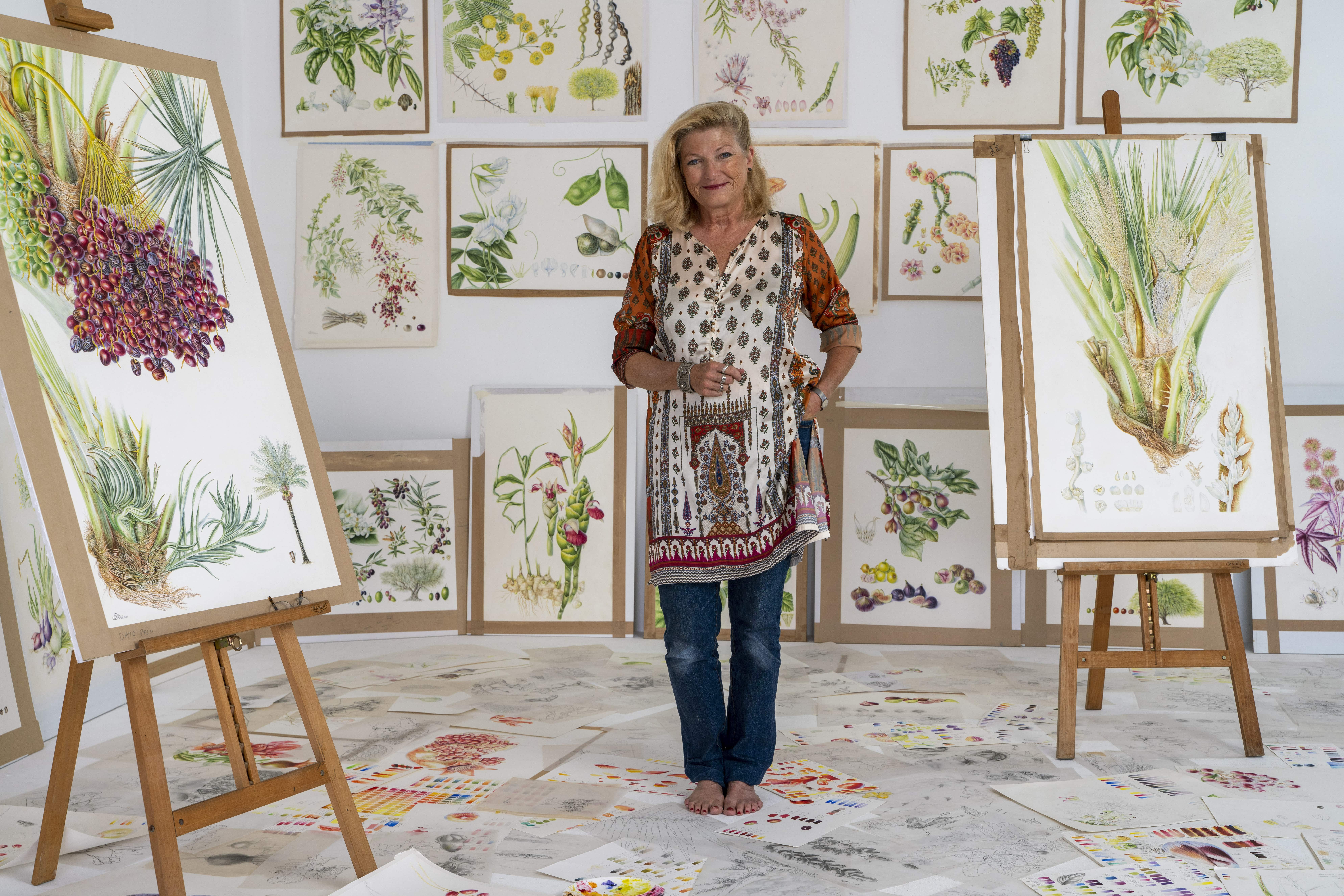 Gallery space filled with intricate botanical paintings