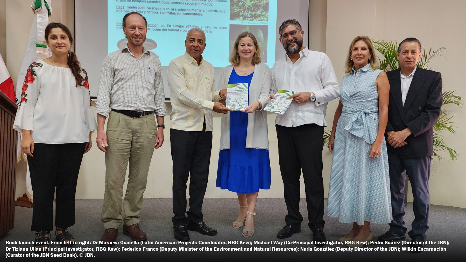 Seven conservationists pose for a photo at a book launch event in the Dominican Republic