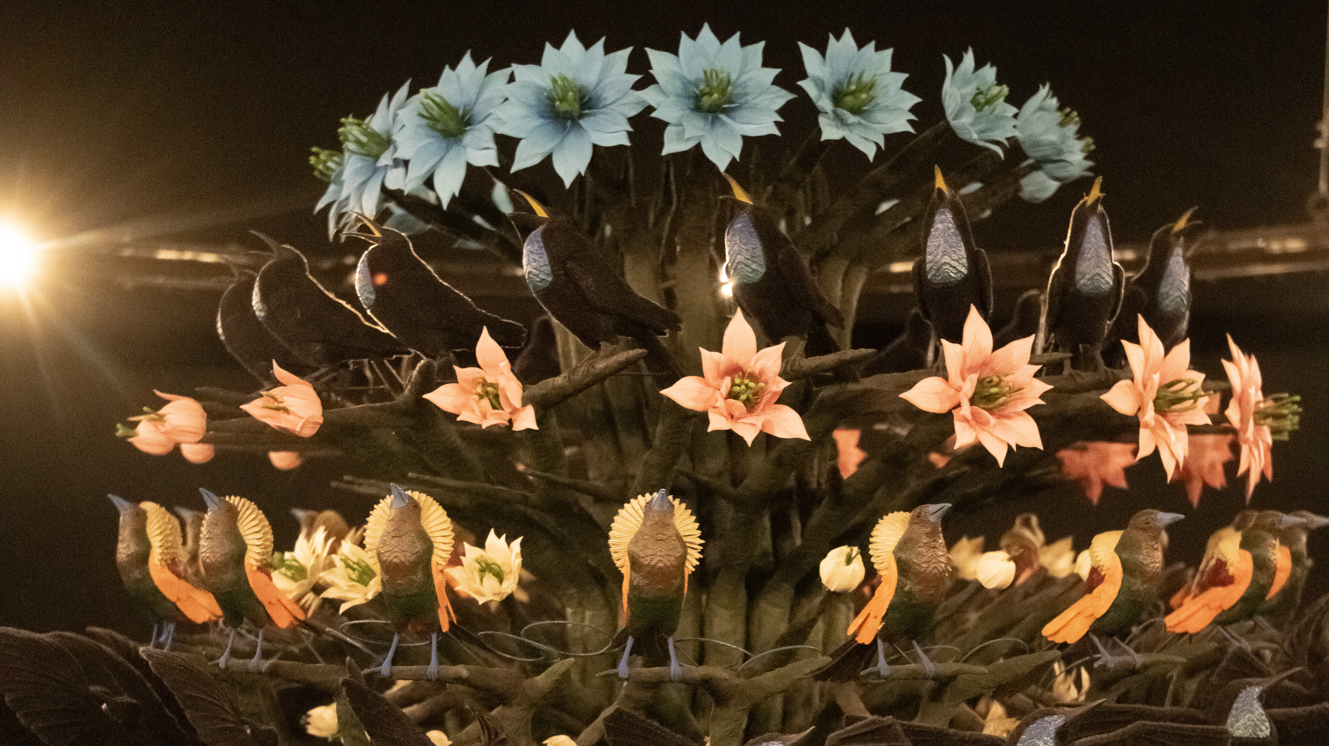 Close up of a giant zoetrope showing 3D printed birds and flowers, arranged in sequential poses around a cylinder