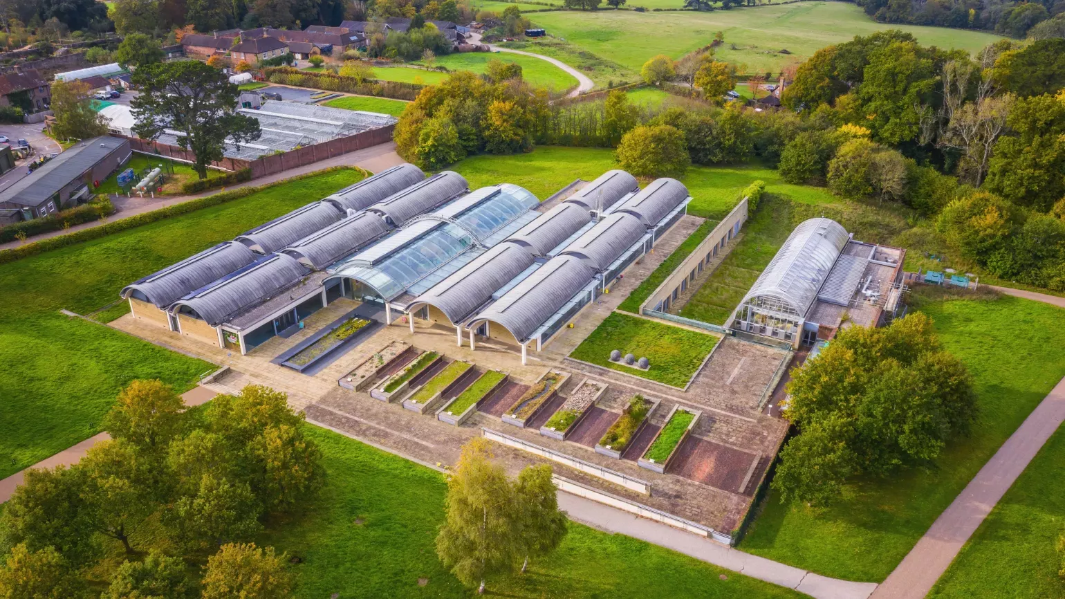 Large glasshouse in a green landscape from above