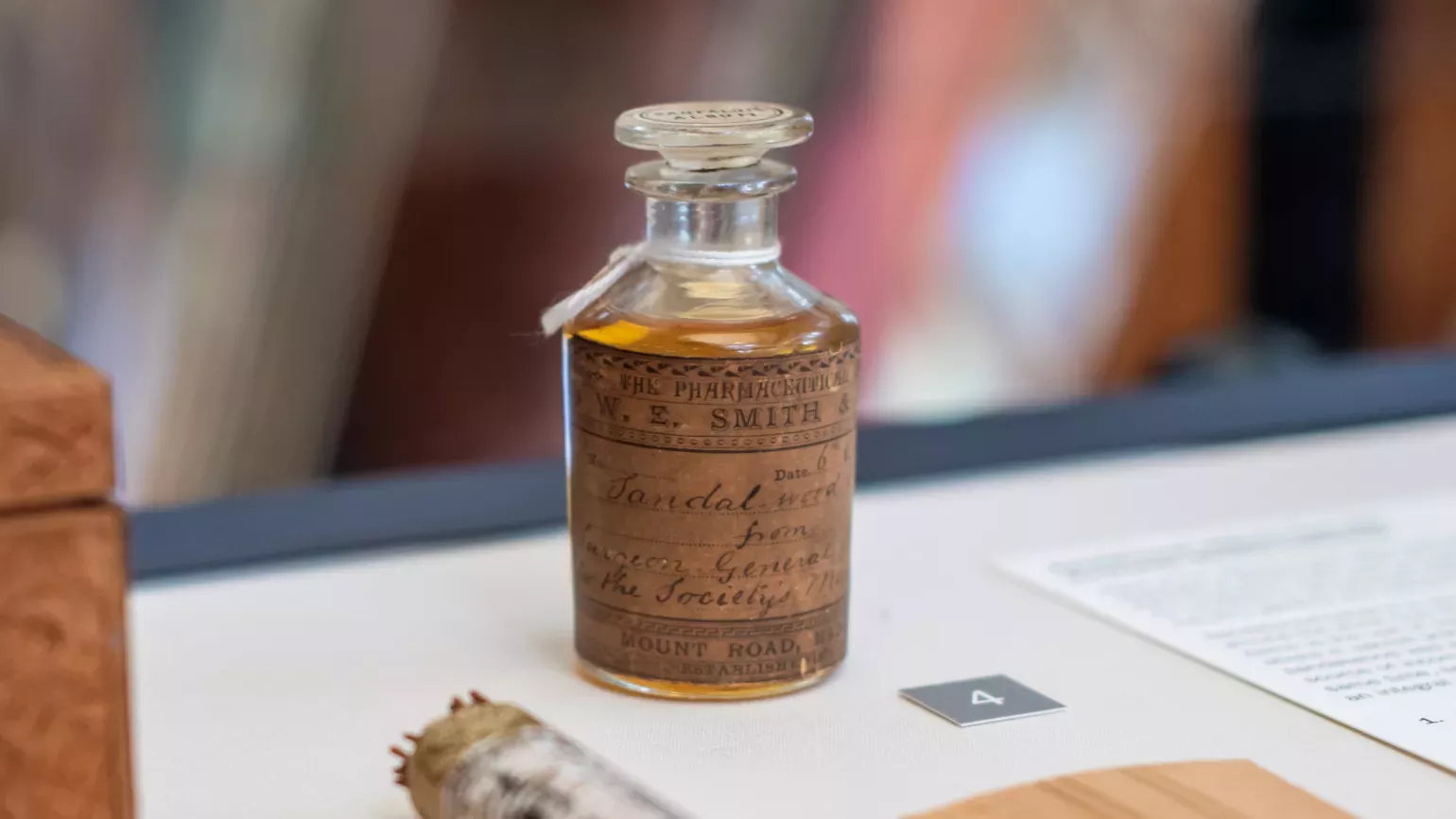 An old glass stoppered bottle of sandalwood oil with an aged handwritten label