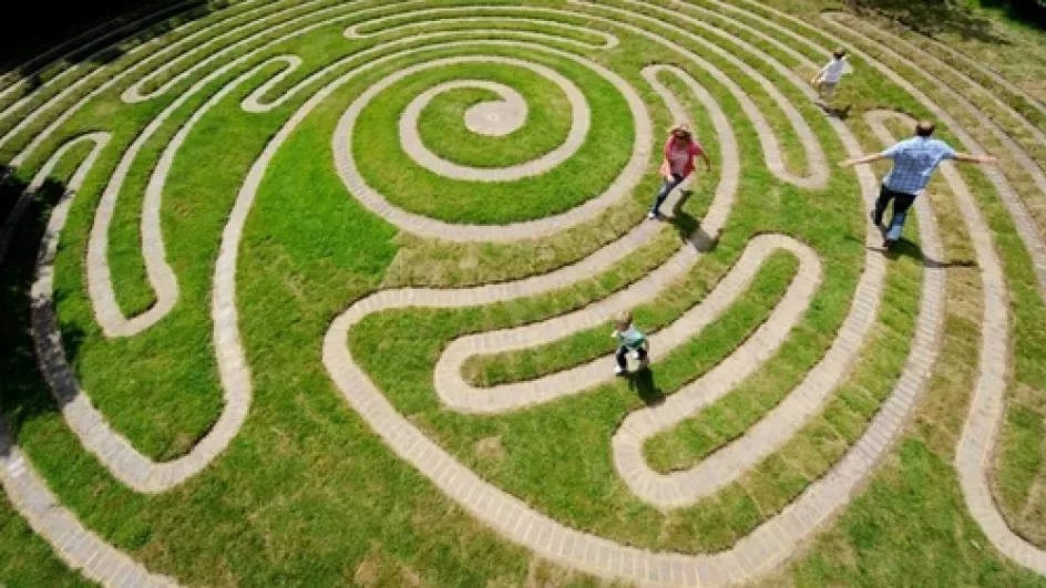 Children run through the Labyrinth at Wakehurst 