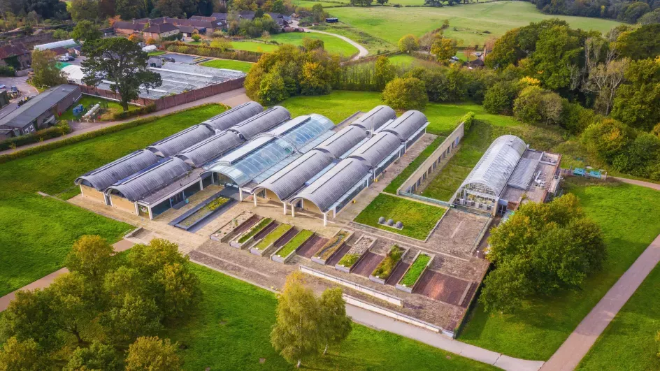 Large glasshouse in a green landscape from above
