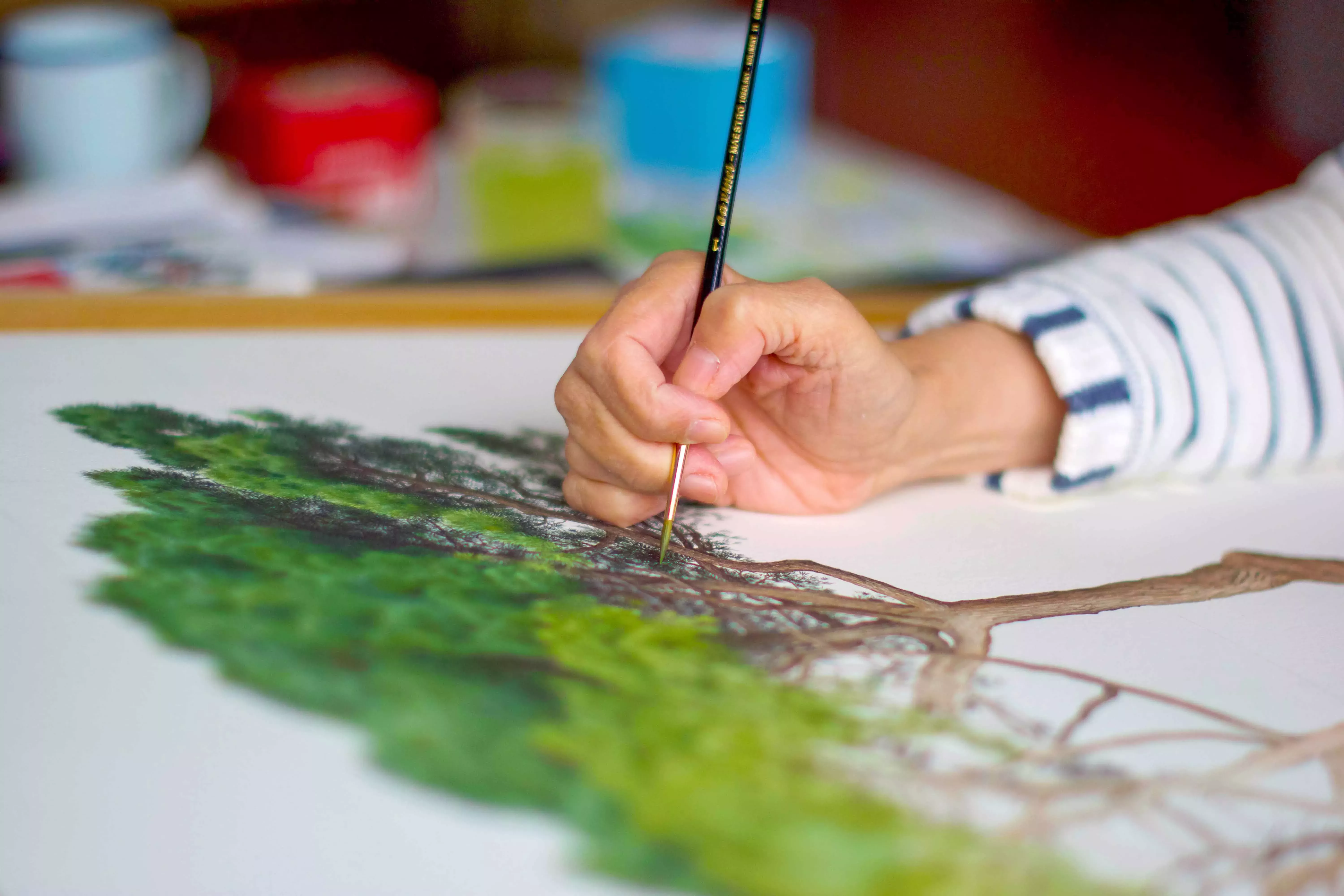 Close-up of botanical artist painting a tree