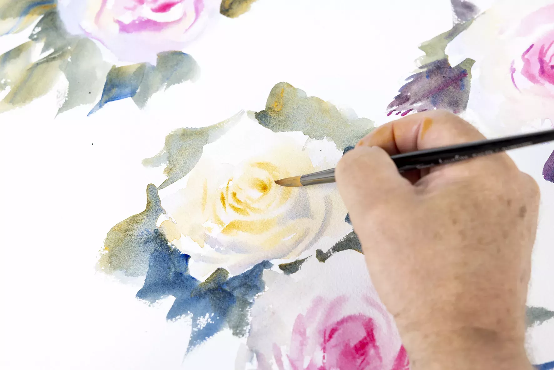 Person painting an image of a flower