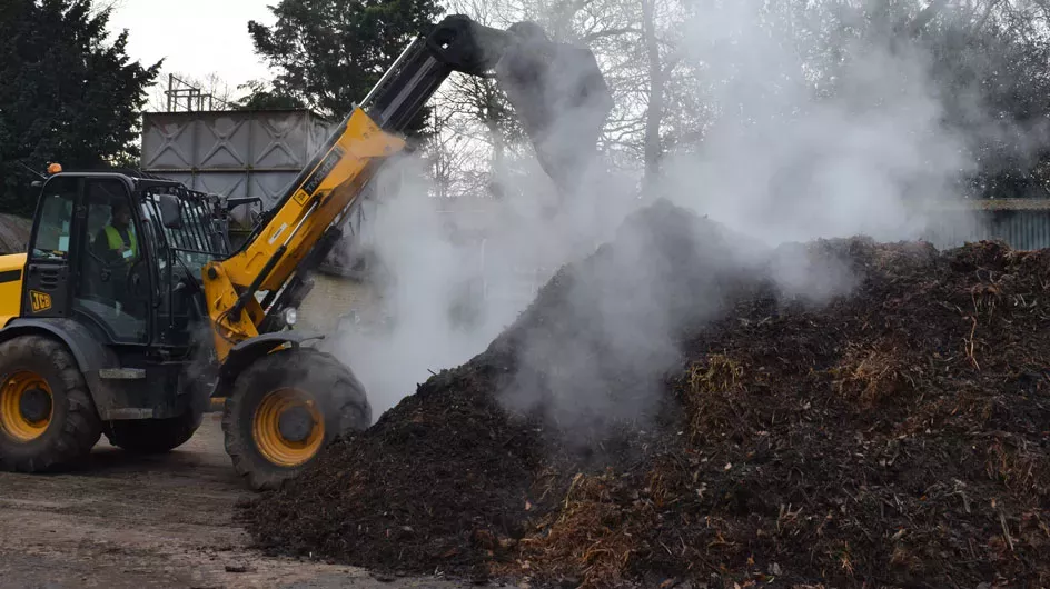 Making mulch at Kew with diggers piling compost